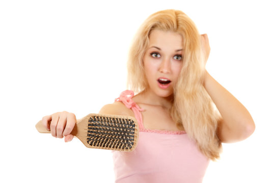 women with hair broblem holding loss hair comb in hand