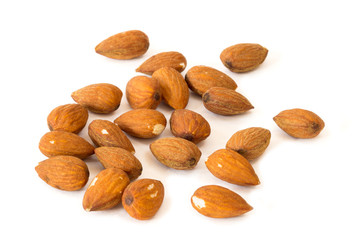 Closeup of several almond seeds, isolated on white background