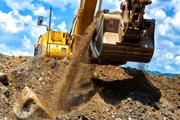 construction excavator moving earth and sand
