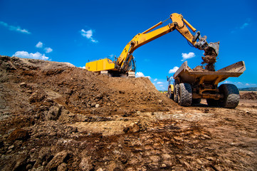 Industrial excavator loading soil material