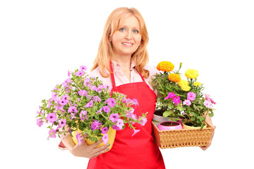 Middle aged female florist holding flowers - Powered by Adobe