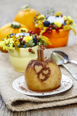 Baked apple decorated with cinnamon heart shape ornament