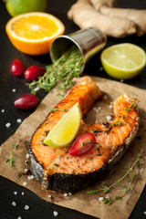 Grilled salmon fish with lime, thyme and orange