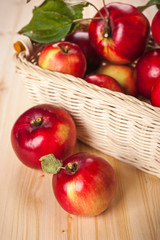 Ripe red apples in a basket on the table