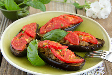 Grilled eggplant with tomatoes and meat.