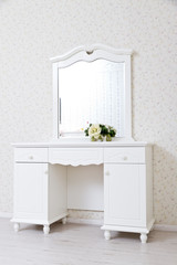 A white dressing table, glass mirror
