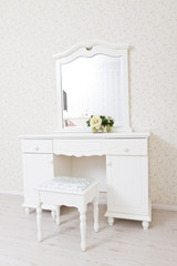 A white dressing table, glass mirror