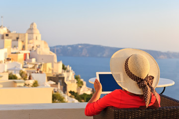 woman with touch pad in Santorini, travel concept