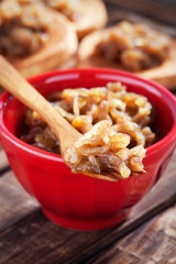 Onion confit in ceramic bowl, selective focus