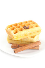 Belgian waffles,coffee beans and cinnamon on a plate isolated on