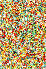 Photo colorful neon sprinkles  candies for background use, top v