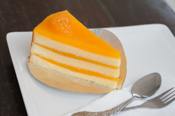 Orange cake on white dish at coffee shop