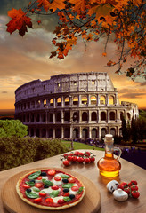 Naklejka premium Colosseum with Italian pizza in Rome, Italy