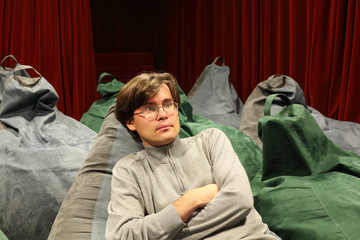 Attentive man watches movie in comfortable seat of small cinema