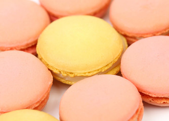 Background of seven various macaron cakes.
