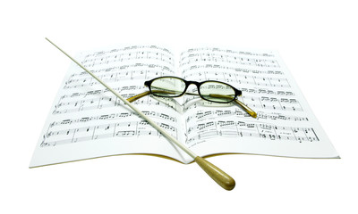 Fototapeta premium Baton and glasses on music score
