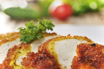 Fried chicken nuggets on the plate on the wooden table