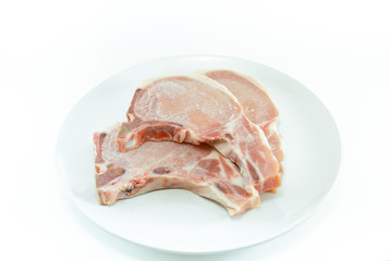 frozen meat ,pork chops ,on white plate