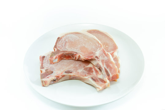 Frozen Meat ,pork Chops ,on White Plate