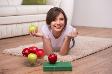 Fototapeta premium Woman relaxing at home. Beautiful young woman lying on the floor