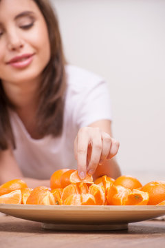 Woman eating oranges. Close-up of woman eating oranges and smili