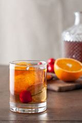 Classic old-fashioned cocktail on a wooden table