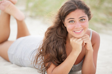 Teenager laying on the sand
