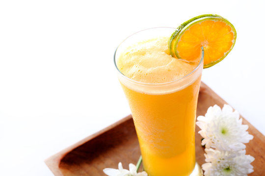 Glass of orange juice and flower