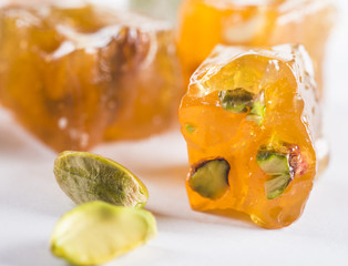 Close-up of turkish delight and pistachios on white background