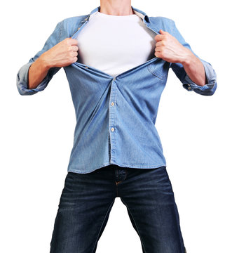 Superhero. Image of young man tearing his shirt off isolated on