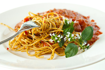 Spaghetti on plate with oregano leaves with flowers