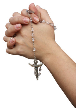 Mani unite in preghiera con corona del Rosario