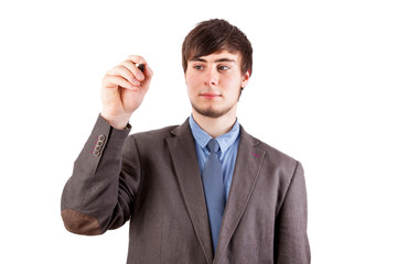 Young businessman with pen on the blackboard