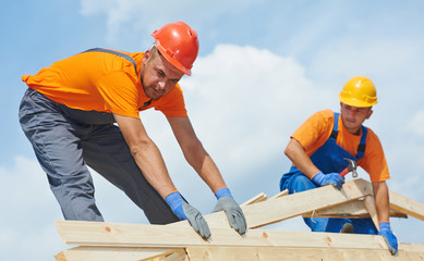 Roofers carpenters works on roof