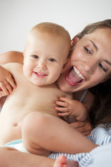Close up portrait fo a mother and child laughing together