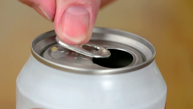 Opening a can of soda using a pull-tab