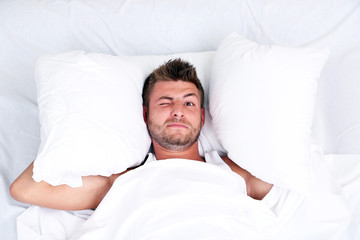 Handsome young man in bed