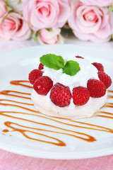 Tasty meringue cake with berries, close up