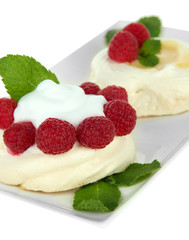 Tasty meringue cakes with berries, isolated on white