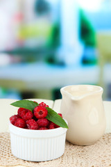 Fresh raspberry  and cream in jug