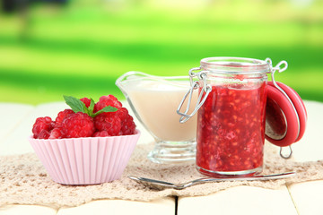 Fresh raspberry, raspberry jam and cream in jug