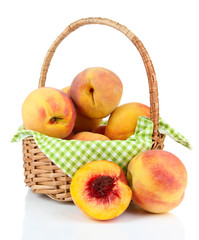Naklejka na ściany i meble Ripe sweet peaches in wicker basket, isolated on white