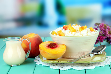 Sour cheese and pieces of fresh peach,on wooden table,
