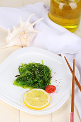 Sea kale on plate on wooden table close-up