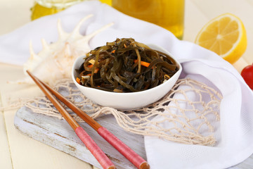 Sea kale in bowl on wooden table close-up