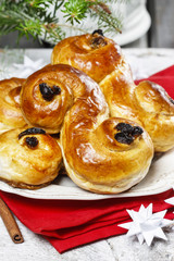 Traditional swedish buns in christmas setting. A saffron bun