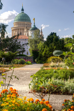 Dome and old town hall in Potsdam behind a flowered park