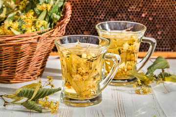 Tea with lime and honey in the garden at summer