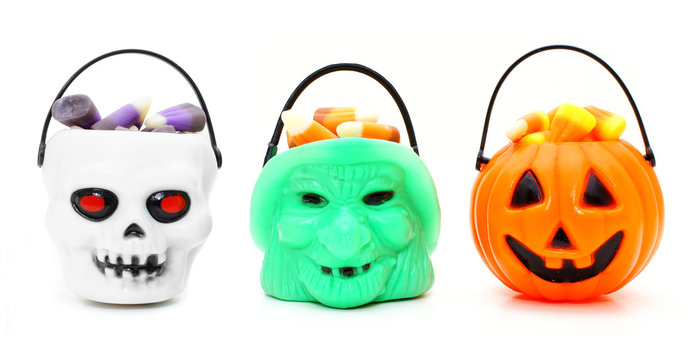 Three types of Halloween candy holders filled with candy corn