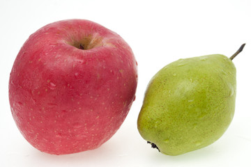 Apple and pear with water droplets on white background